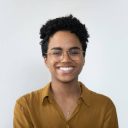 Happy millennial Afro American business woman in casual glasses posing isolated on white, smiling with perfect white teeth. Confident female customer, professional head shot portrait